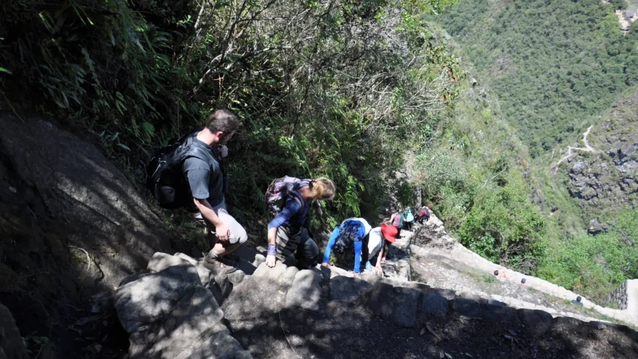 Hikers climbing steep Inca stone steps on the Inca Trail