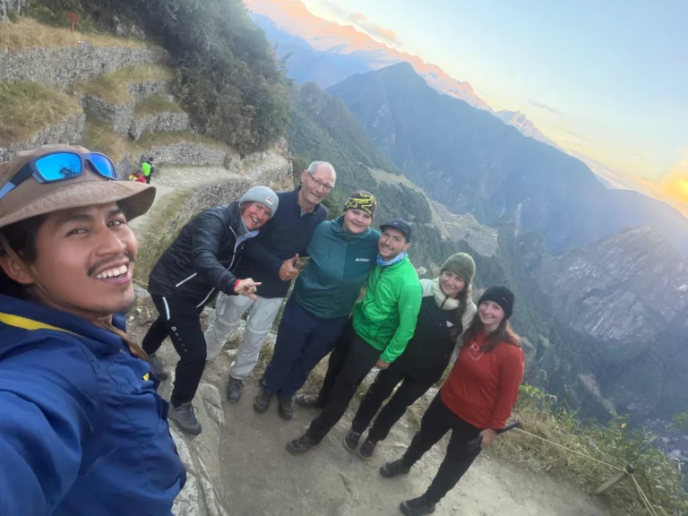 Hikers with their guide on the Inca Trail at sunrise above Machu Picchu