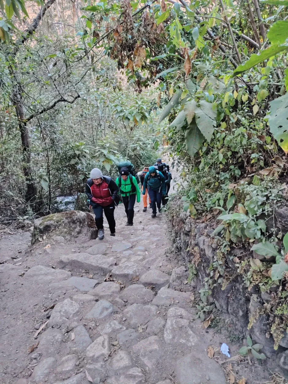 Hikers walking on an Inca stone path on the Inca Trail