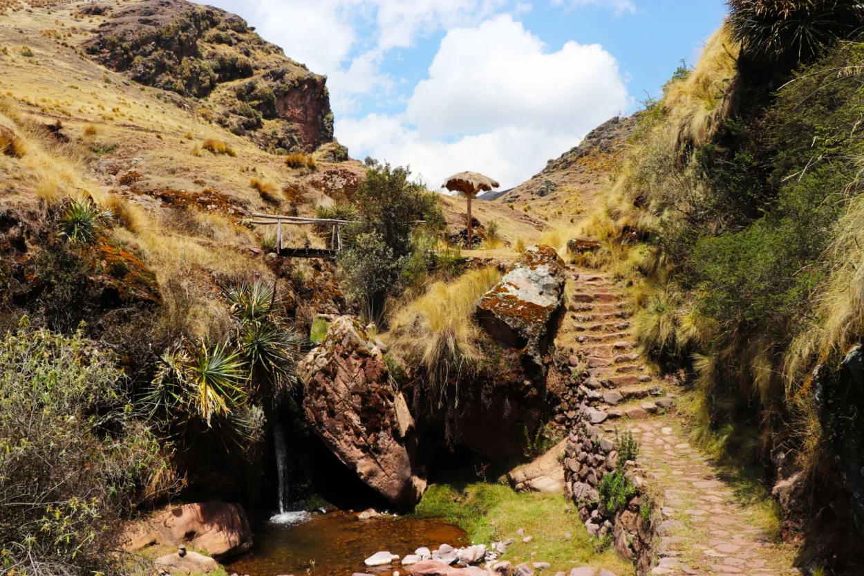 Stone path and small waterfall in the gorge on the Huchuy Qosqo trek