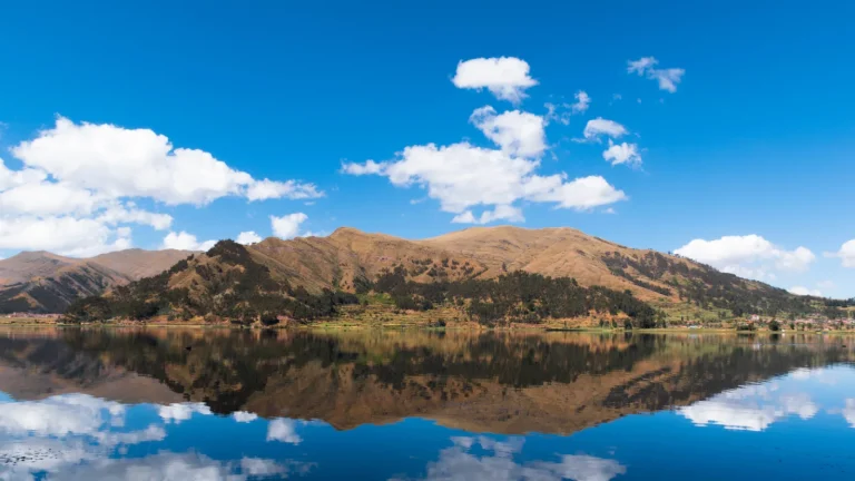 Piuray Lake near Chinchero reflecting the sky and the Andes