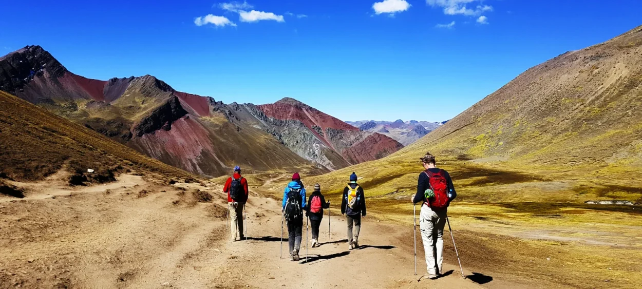 Hikers walking on the trail to Rainbow Mountain