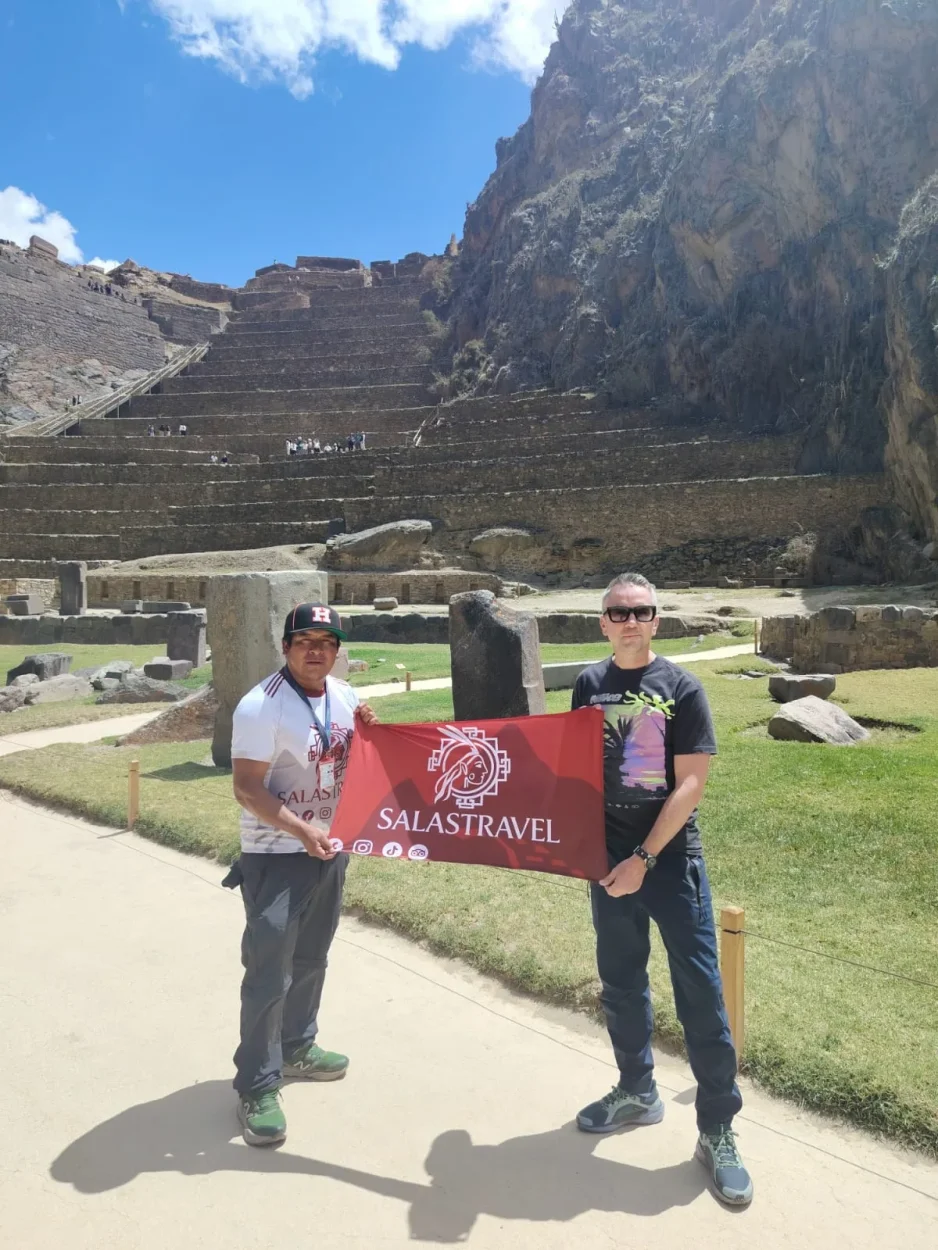 Salas Travel guide and a traveler below the Inca terraces of Ollantaytambo